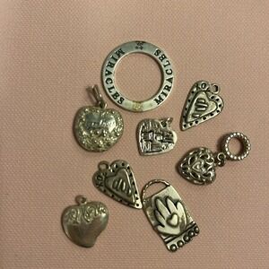 8 Sterling charms, great on necklace or bracelet.‎  7 hearts, one Miracle disc.
